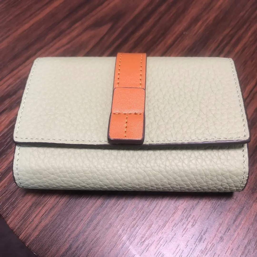 Thumbnail of Light green trifold wallet, leather, bills also fit.
