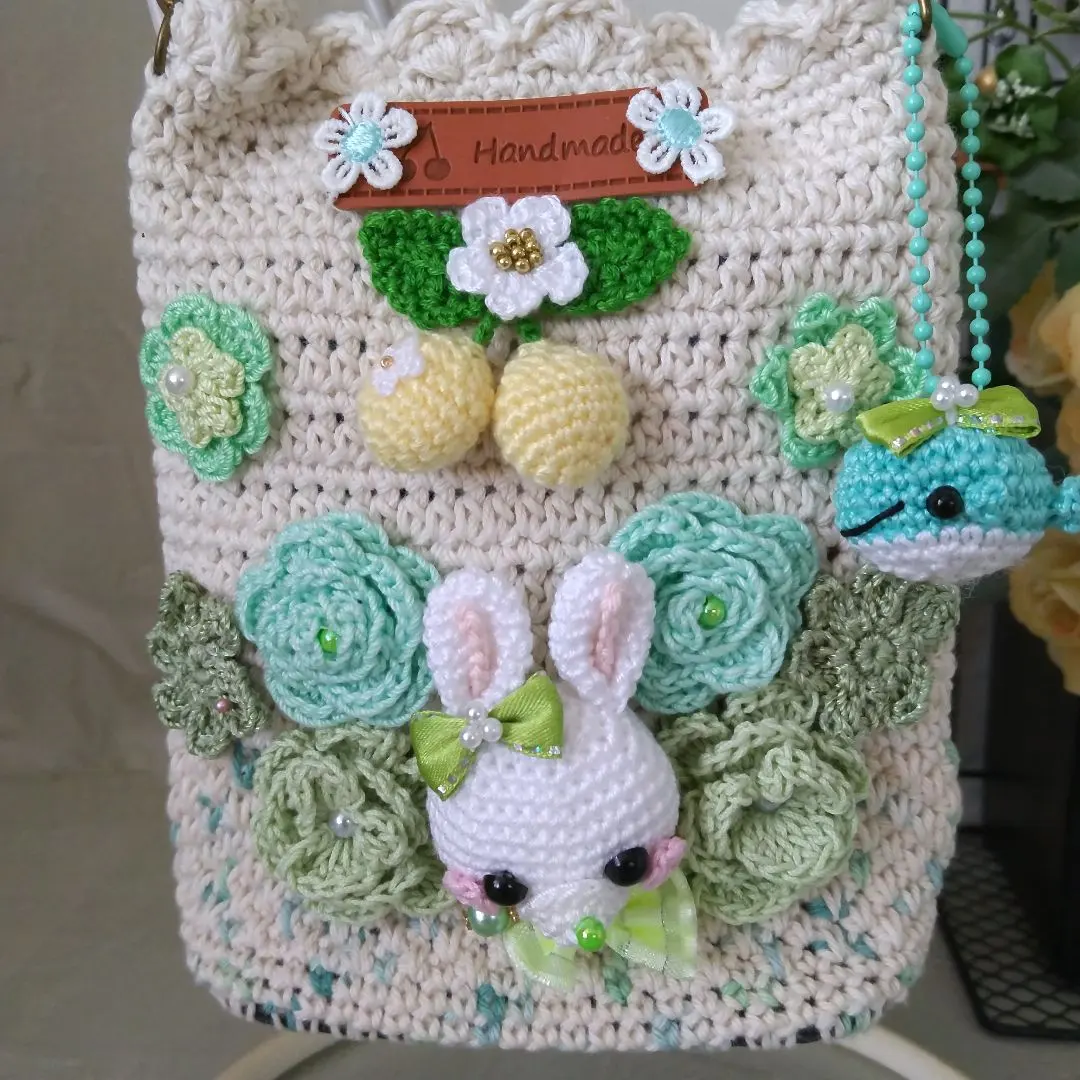 Thumbnail of Hand-knitted shoulder bag with rabbits and flowers
