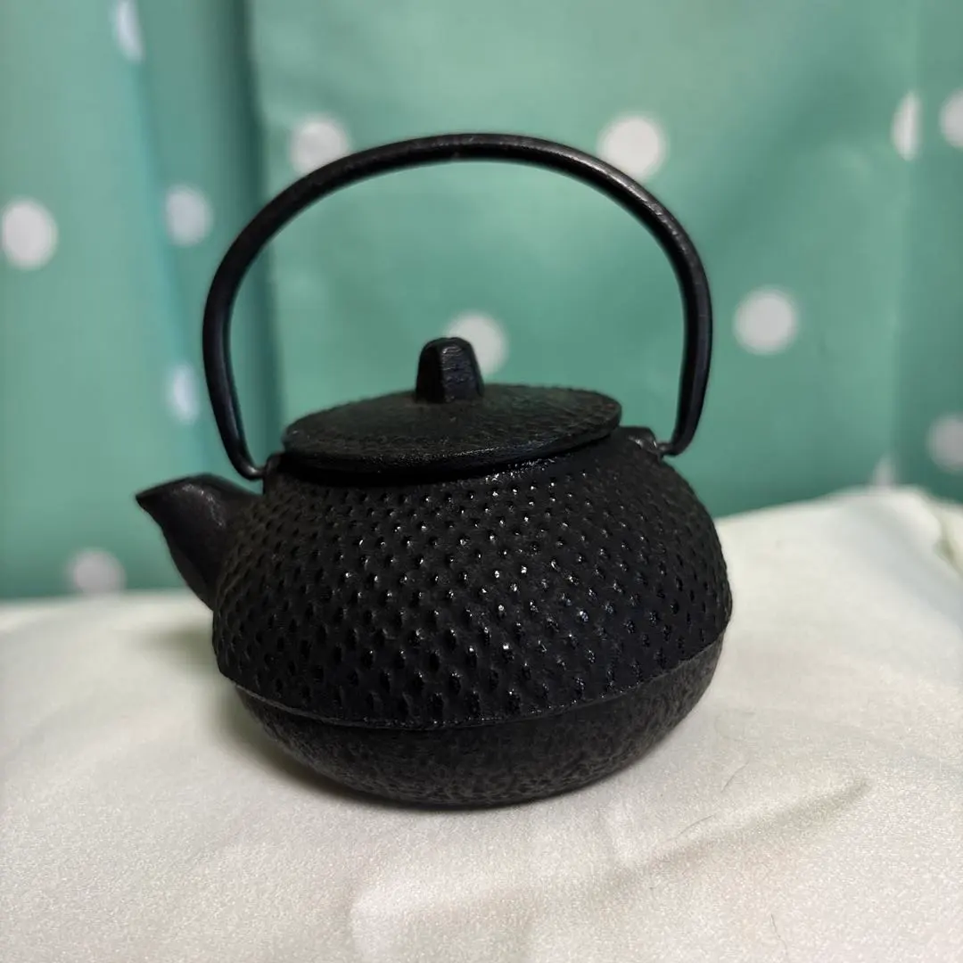 Thumbnail of Black cast iron paperweight with a mesh pattern