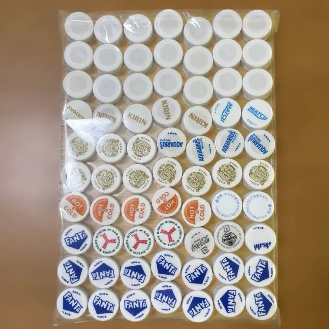 Thumbnail of Plastic bottle caps, white/light colors, 70 pieces