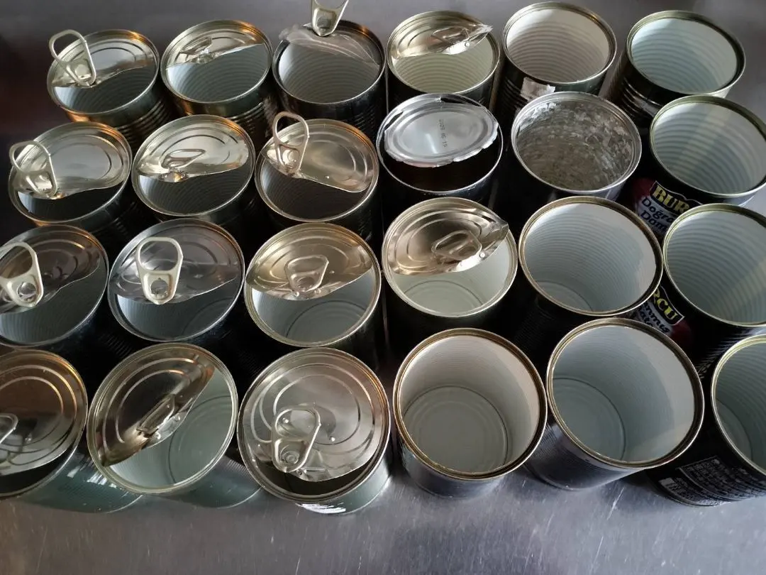 Thumbnail of 24 empty tomato and corn cans
