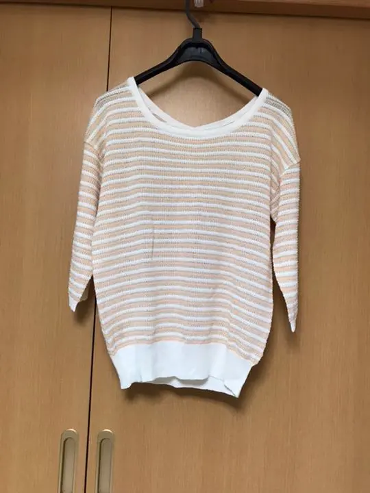 Thumbnail of Pale orange striped summer sweater with a ribbon in the back
