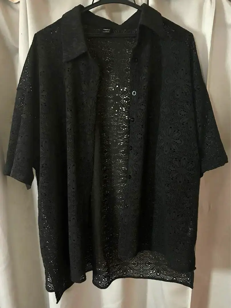 Thumbnail of Black short-sleeved shirt with lace flower pattern