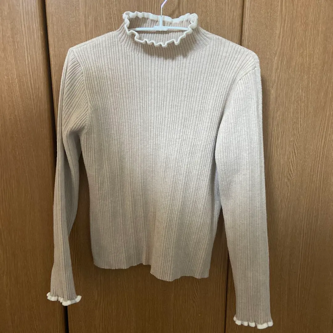 Thumbnail of Cute beige knit sweater with a neckline detail
