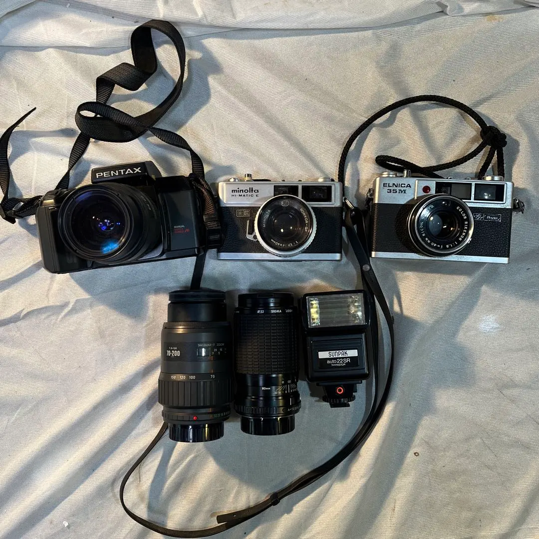 Thumbnail of Minolta, Pentax, and Ricoh cameras (3), lenses (2), and a flash unit (1) set