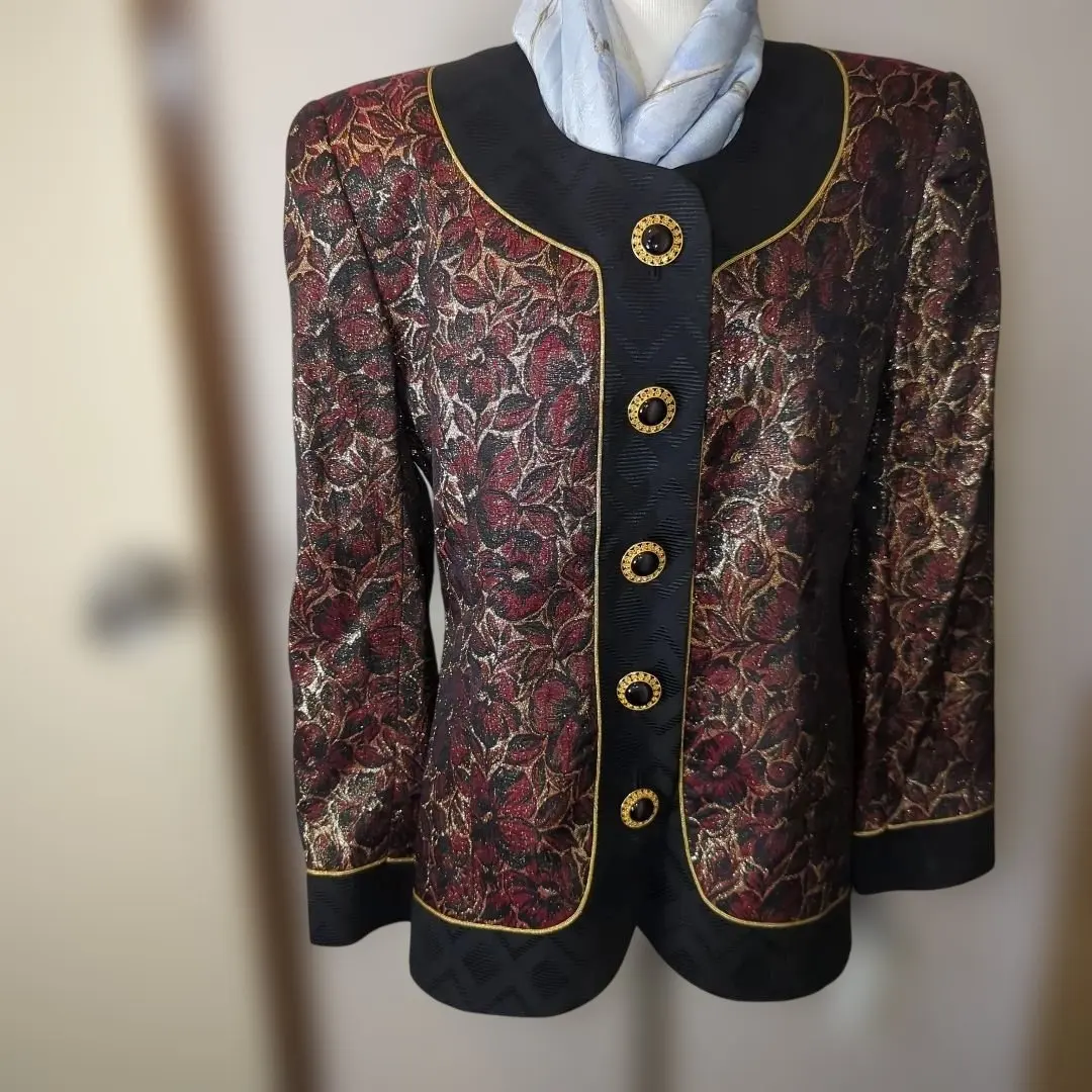 Thumbnail of Red and black floral patterned gold-trimmed collarless jacket with black chalcedony buttons. Luxurious.