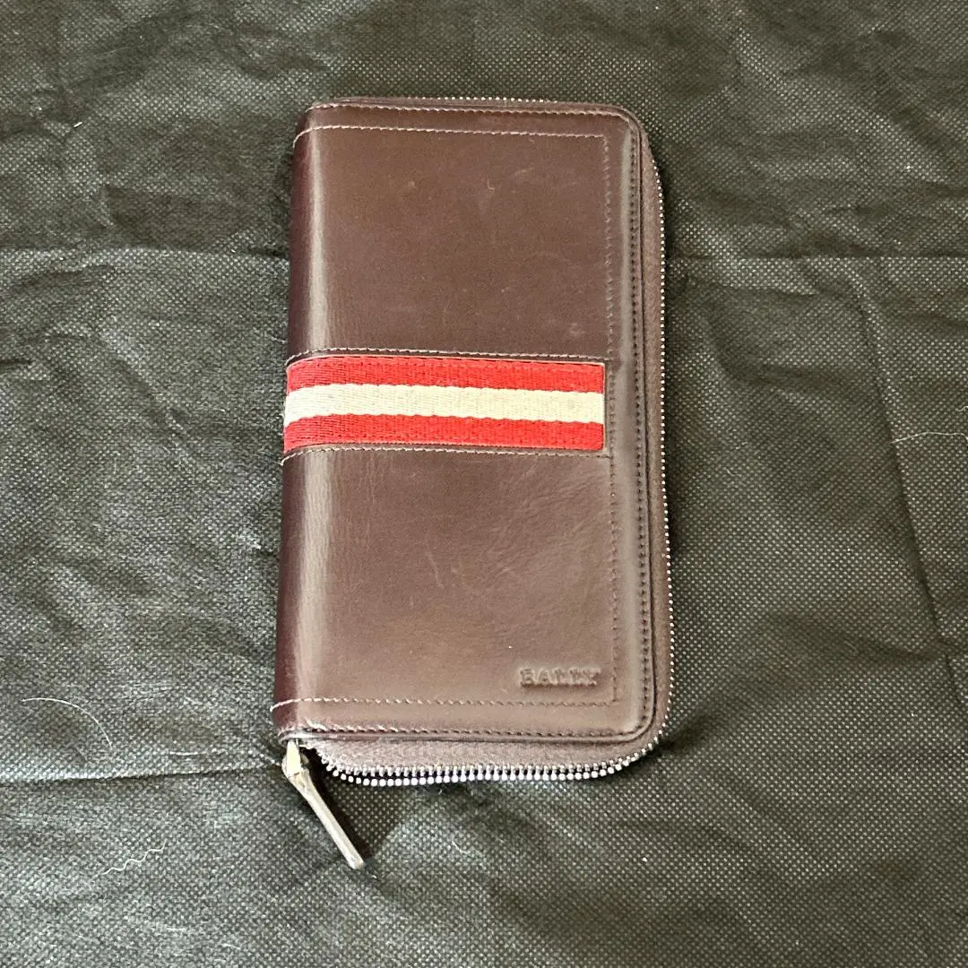 Thumbnail of BALLY men's long wallet, brown, with stripe design and zip-around closure