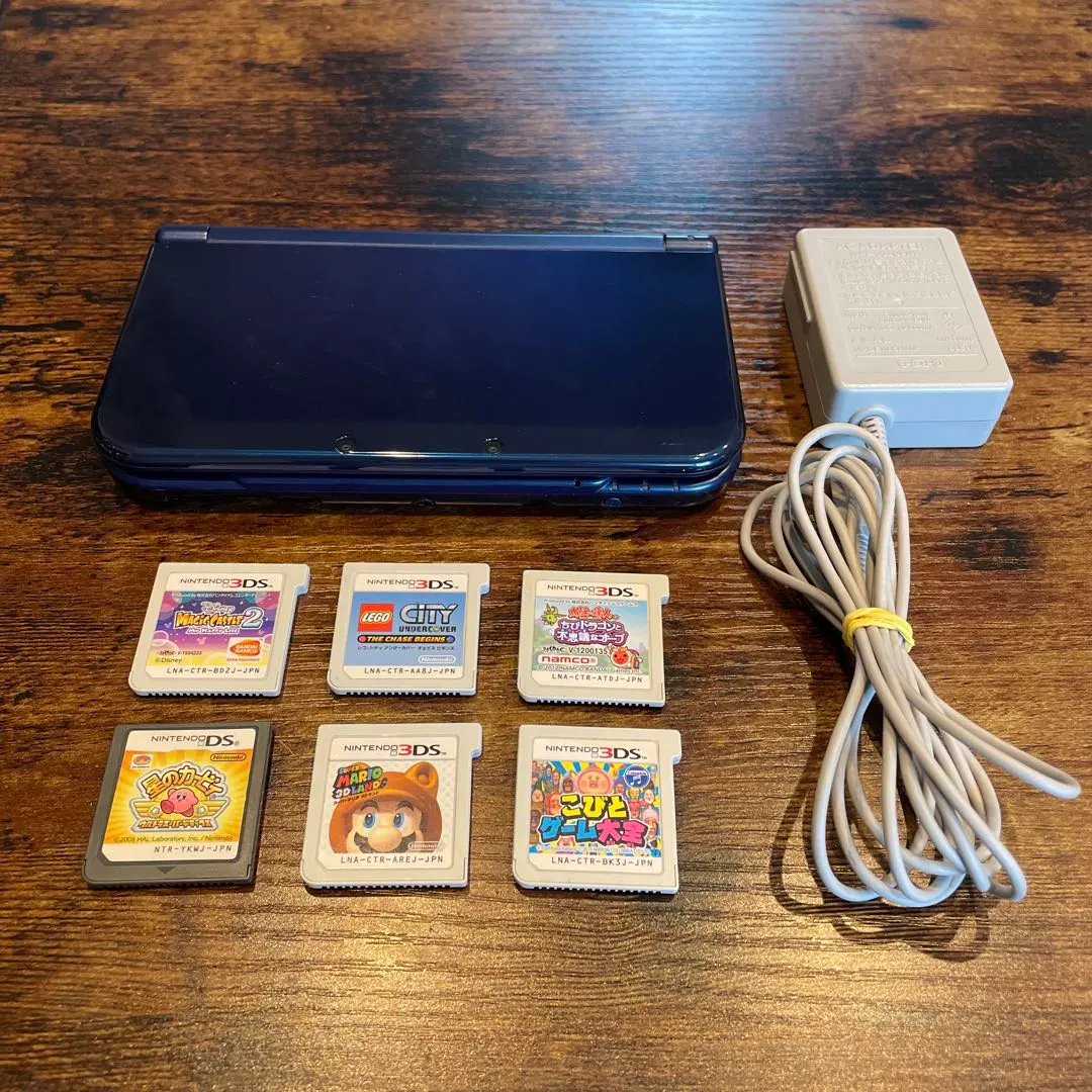 Thumbnail of New 3DS LL console, AC adapter, and 6 game cartridges included as bonus