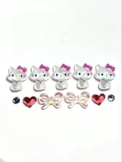 Nail art parts featuring Charmy Kitty, ribbons, and hearts.