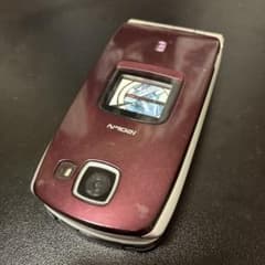 Display model of N902i (dark wine color) - Docomo feature phone model.