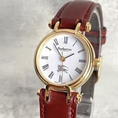 Working condition Burberry gold antique white dial wristwatch.