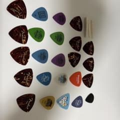 Guitar string instrument picks and nuts, bundled, random mix.