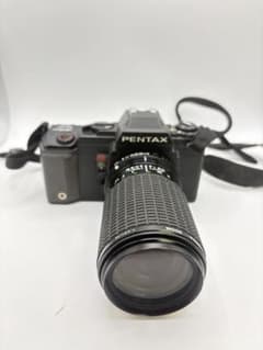 PENTAX film SLR camera body with SIGMA lens