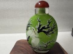 Glass snuff bottle with a crane and bamboo design, a popular Chinese art piece, perfect as a gift or talisman.