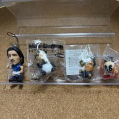 A set of four accessories featuring Crayon Shin-chan and a baby cow charm.