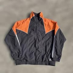 adidas ナイロンジャケット オレンジ/ブラック - メルカリ