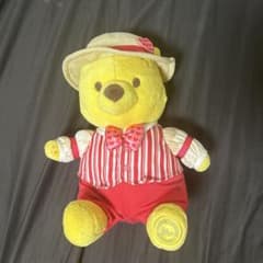 Winnie the Pooh plush toy with heart-patterned outfit