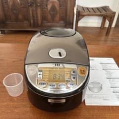 Zojirushi NP-VC10 IH Rice Cooker - Includes instruction manual and measuring cup.