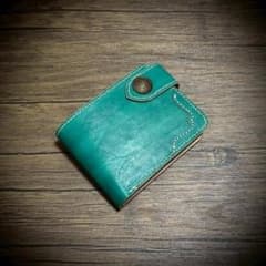 Hand-stitched men's bi-fold wallet, made from genuine vegetable-tanned leather, with a concho.