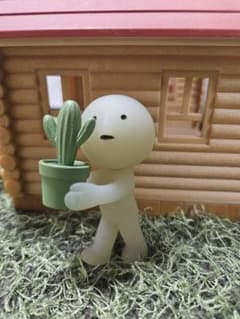 Cream-colored doll with cactus