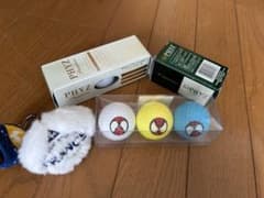 Spider-Man golf balls (3-pack), plus a Le Coq Sportif golf ball case (2-ball capacity).