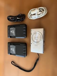 Canon IXY 100F with 2 batteries, 2 chargers, and USB cable included.