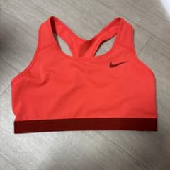 Brand new, unused Nike sports bra, orange, cross-back, size L.