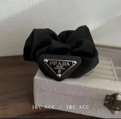 PRADA シュシュ ブラック トライアングルロゴ - メルカリ