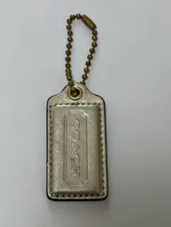 COACH シャンパンゴールド チャーム　タグ型キーホルダー