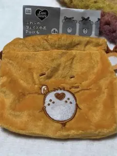ケアベア　ふわふわフェイス 巾着　オレンジ　ガチャガチャ