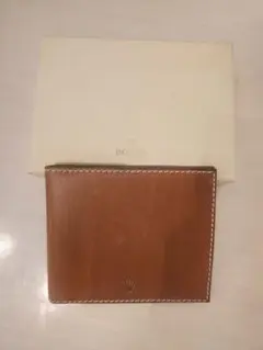 ♥️ROLEXブラウンレザー 二つ折り財布 王冠マーク ROLEX】王冠マーク 2つ折り長財布 ノベルティ 未使用品 - メルカリ