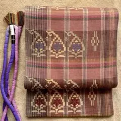 リバーシブルの紬地袋帯と丸ぐけ帯締めのセット ピンク 紫