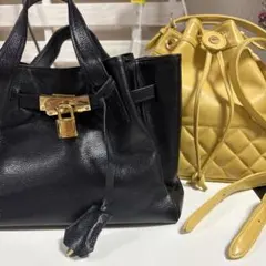 黒いロック付きハンドバッグと黄色いショルダーバッグのセット