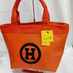 新品未使用オレンジに Ｈブラックマークがエナメル