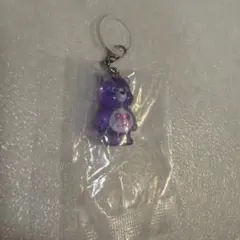 新品未開封品: ケアベア 紫色 めじるしアクセサリー