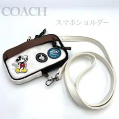 COACH Disney コラボ スマホショルダー ホワイト シグネチャーPVC