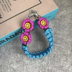【再販】パラコード　ハンドスマホストラップ　☺︎ニコちゃん☺︎ お花　ハンドメイド