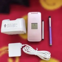 Foldable mobile phone (pink), charger, and pen set.