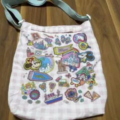 【最終お値下げ】東京ディズニーリゾート 総柄 ショルダーバッグ　新品のサムネイル