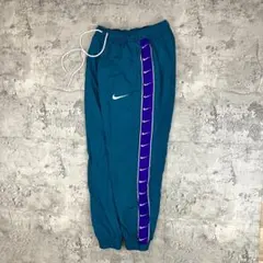 NIKE ナイキ ウーブンパンツ 古着 刺繍 スウッシュ サイドライン テープ
