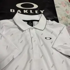 未使用サイズL/OAKLEY/全面ロゴ柄プリントQUICK DRY半袖ポロシャツ