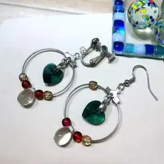 リングの中で緑のハートが揺れる♪選べるピアスかイヤリング