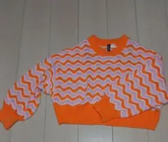 オレンジとピンクの波模様ニットセーター
