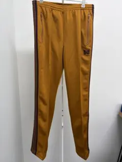 2026年最新】needles トラックパンツ マスタードの人気アイテム - メルカリ
