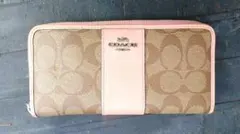 『COACH シグネチャー ラウンドファスナー　長財布 ピンク ベージュ』