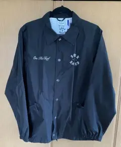BORN X RAISED ROCKER コーチジャケット Coaches Jacket in black. BXR rocker embroidered on front