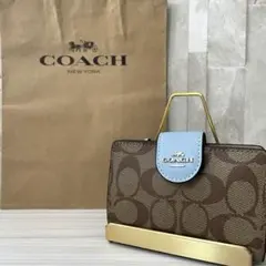 早い者勝ち！訳あり新品 COACH 二つ折り財布 シグネチャー総柄 茶色×水色