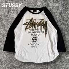 STUSSY ラグランTシャツ　ワールドツアー　スプレーアート　ゴールド　M STUSSY ラグランTシャツ ワールドツアー スプレーアート ゴールド M