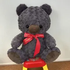 グレーのクマのぬいぐるみ（赤いリボン付き）