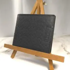 【新品未使用】コーチ　二つ折り財布　シグネチャー柄　ブラック